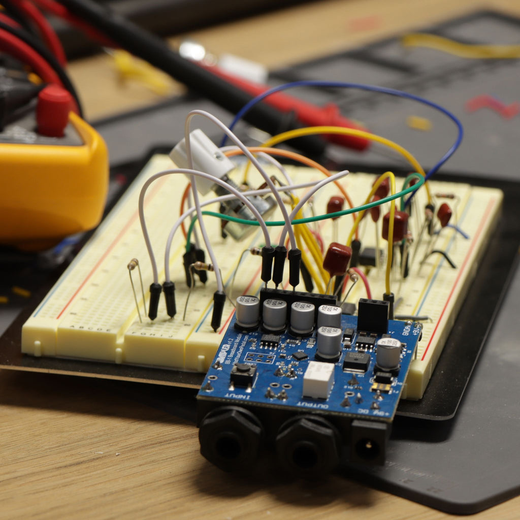 BB-1 breadboard module plugged into a breadboard with a guitar pedal circuit wired up